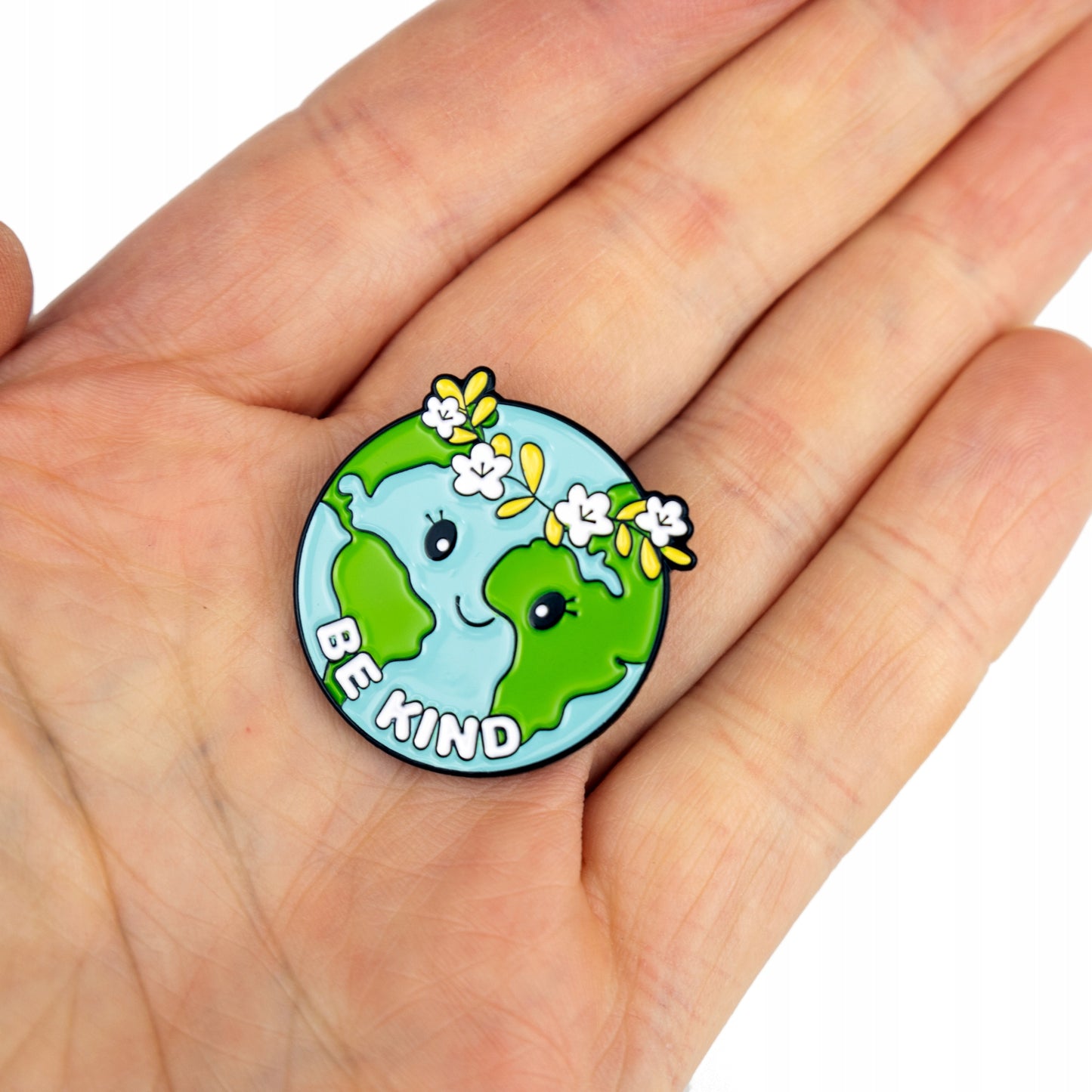 Insignă ecologică în formă de planetă Pământ cu o coroană cu sloganul „Fii bun”