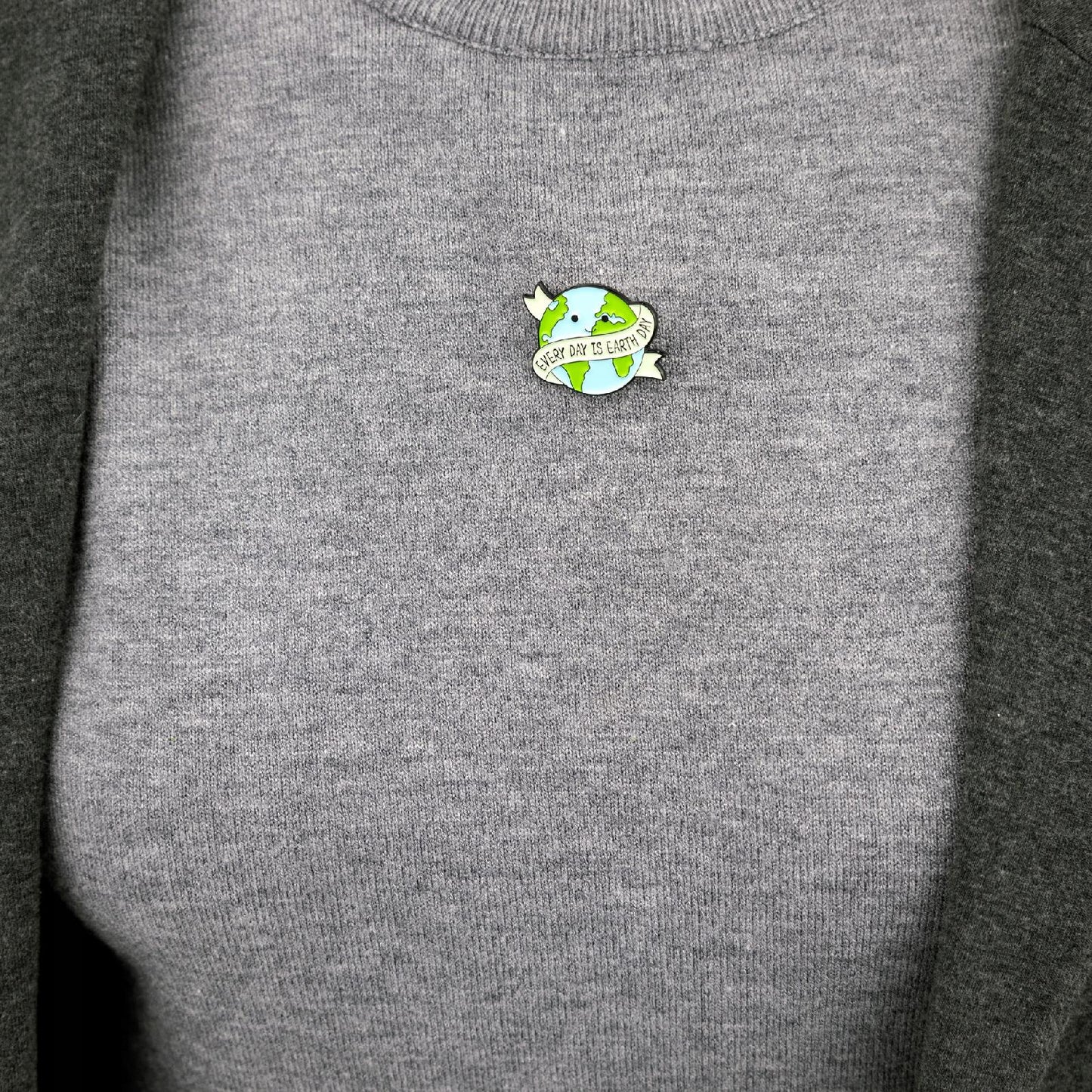 Insignă ecologică în formă de planetă Pământ cu sloganul „Fiecare zi este Ziua Pământului”